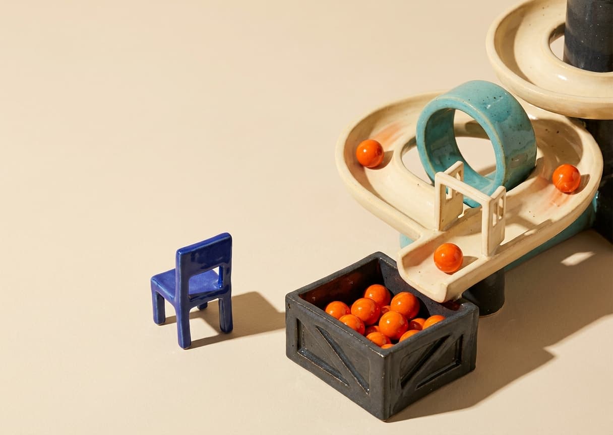 Walking away: the machine keeps feeding orange spheres through its gates and into the crate, with nobody watching
